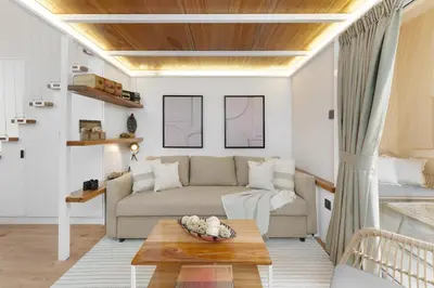 a living room with a couch and a table at Extraordinary Loft Living in JVC by Suiteable in Dubai