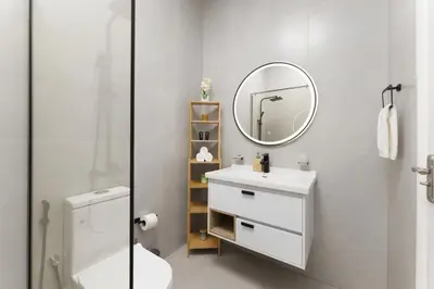 a bathroom with a white sink and a mirror at Extraordinary Loft Living in JVC by Suiteable in Dubai