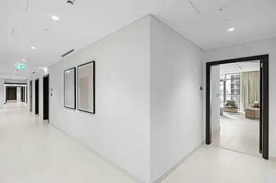 a hallway with white walls and black doors at Silkhaus Sea View 1BDR Luxurious New Tower in Dubai