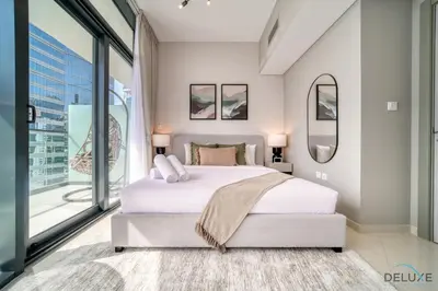 a bedroom with a large bed and a large window at Canal Views! Promotional Rate on Lovely 1BR by Deluxe Holiday Homes in Dubai