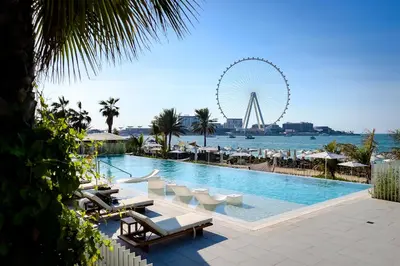 a swimming pool with a ferris wheel in the background at Luxury apartments at La Vie in Dubai