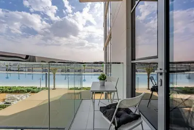 a view of the pool from the balcony of a house at District One I MBR I Spacious and Cozy in Dubai