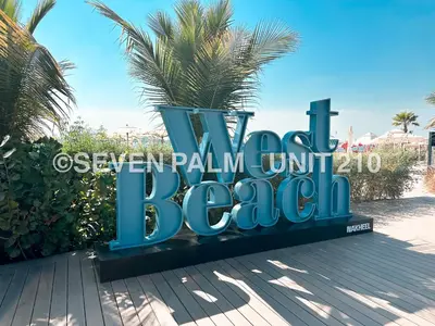 a sign for the beach at the excellence pala hotel at Luxus-Studio mit Private Beach in Top-Lage, Meerblick & Infinity Pool! in Dubai