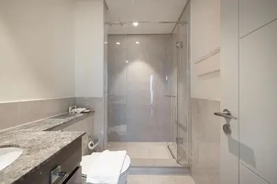 a bathroom with a shower with a toilet and a sink at Forte Tower 1 - Fantastic Two Bedroom in Downtown Dubai in Dubai