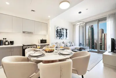 a kitchen and living room with a table and chairs at Forte Tower 1 - Fantastic Two Bedroom in Downtown Dubai in Dubai
