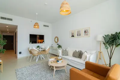 a living room with a couch and a table at Elite Escape Holiday Home - 2 BHK Getaway with Burj Khalifa View and Dubai Mall Access - 1504 in Dubai