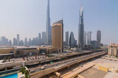 a view of a city with a highway and buildings at Elite Escape Holiday Home - 2 BHK Getaway with Burj Khalifa View and Dubai Mall Access - 1504 in Dubai