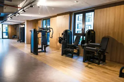a gym with several tread machines in a room at Brand New 2BR in La Rive with SeaView, Pool & Gym in Dubai