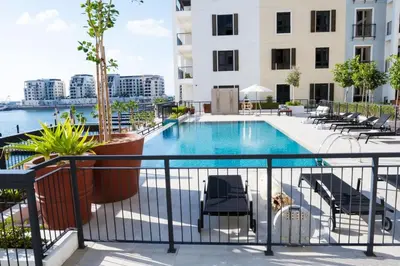 a swimming pool on the balcony of a building at Brand New 2BR in La Rive with SeaView, Pool & Gym in Dubai