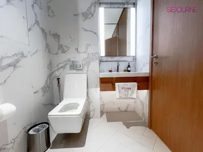 a white bathroom with a toilet and a sink at #25 High end 2BR in The Address Dubai Opera in Dubai