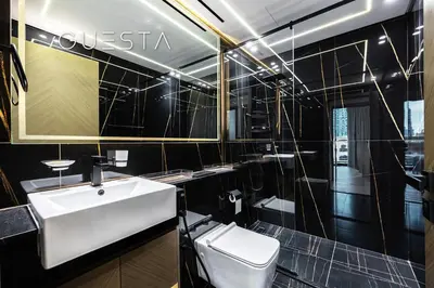 a bathroom with a white sink and a toilet at Binghatti Crescent, Jumeirah Village Circle in Dubai