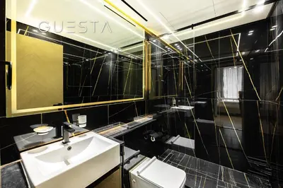 a black tiled bathroom with a sink and a mirror at Binghatti Crescent, Jumeirah Village Circle in Dubai