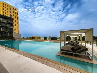a swimming pool with a bed in a hotel at Binghatti Crescent, Jumeirah Village Circle in Dubai