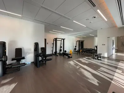 a gym with several treadmills and machines in a room at Silkhaus Heart of Downtown High Floor with View in Dubai