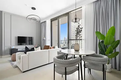 a living room with a white couch and a table at Silkhaus Heart of Downtown High Floor with View in Dubai