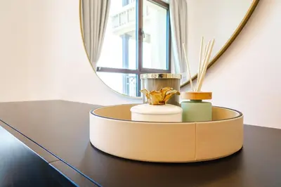 a round table with two candles on it in front of a mirror at Peaceful 2BR Retreat Near Burj Al Arab in Dubai
