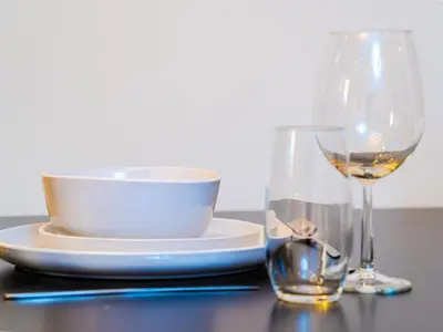 a table with a bowl and a glass of wine at Cozy Studio with Burj Khalifa Views in Dubai