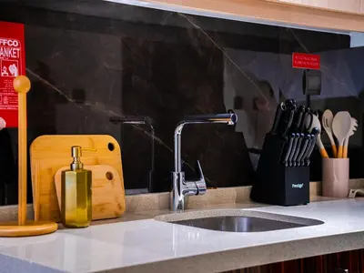 a kitchen sink with a faucet and a counter at Cozy Studio with Burj Khalifa Views in Dubai