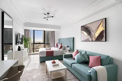 a living room with a couch and a bed at StoneTree - Cozy Studio - JLT in Dubai