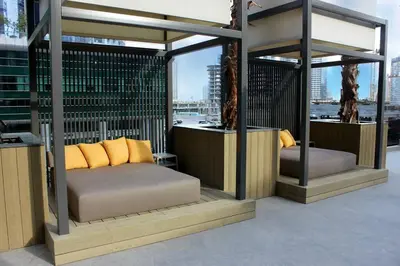 a canopy bed with pillows on a balcony at Розкішна квартира з видом на Бурж Халіфа in Dubai