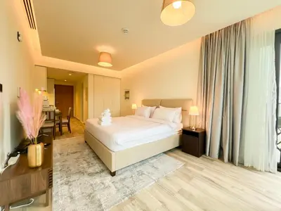 a hotel room with a bed and a table at Luxury Studio with Unobstructed Burj Khalifa View - 23AB08 in Dubai