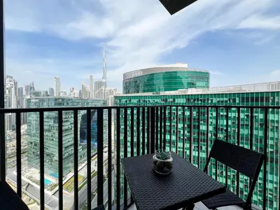 a balcony with a table and a view of a city at Luxury Studio with Unobstructed Burj Khalifa View - 23AB08 in Dubai