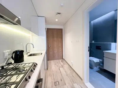 a kitchen with a stove and a sink and a toilet at Luxury Studio with Unobstructed Burj Khalifa View - 23AB08 in Dubai