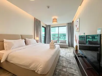 a bedroom with a large bed and a television at Luxury Studio with Unobstructed Burj Khalifa View - 23AB08 in Dubai