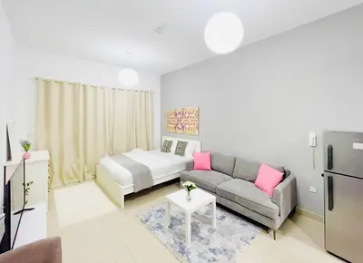 a living room with a couch and a bed at Studio Apartment in Dubai Marina with Balcony in Dubai