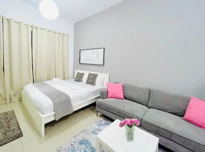a living room with a bed and a couch at Studio Apartment in Dubai Marina with Balcony in Dubai