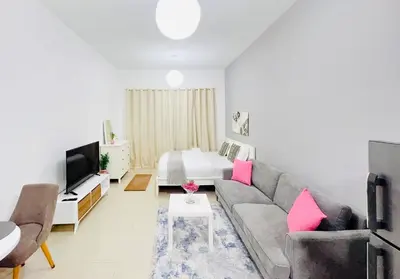 a living room with a couch and a bed at Studio Apartment in Dubai Marina with Balcony in Dubai