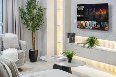 a living room with a chair and a coffee table at Classic 1 Bed Suite in The Residence Tower 3 in Dubai