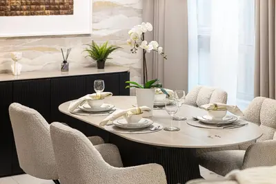 a dining room table with chairs and a table and chairsktop at Classic 1 Bed Suite in The Residence Tower 3 in Dubai