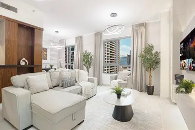 a living room with a couch and a table at Classic 1 Bed Suite in The Residence Tower 3 in Dubai