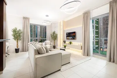 a living room with a couch and a tv at Classic 1 Bed Suite in The Residence Tower 3 in Dubai
