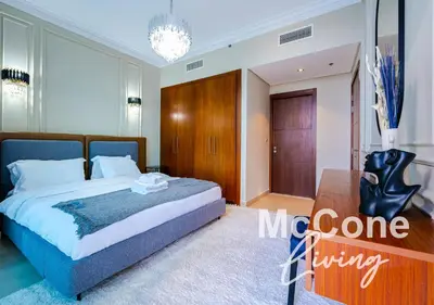 a bedroom with a bed and a chandelier at Classic 1 Bed Suite in Burj Vista Tower, Downtown in Dubai