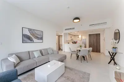 a living room with a couch and a table at Stylish 1BR in Wasl 1 with Balcony & Pool in Dubai