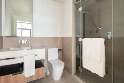 a bathroom with a toilet and a sink and a shower at Frank Porter - DT1 Tower in Dubai