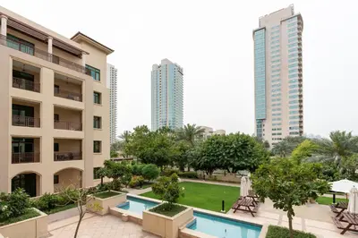 a view of the courtyard of a hotel with buildings at Lux BnB I Turia Tower I Lake & Garden View in Dubai