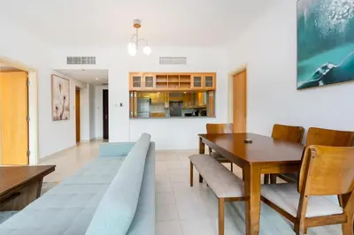 a dining room with a table and chairs at Lux BnB I Turia Tower I Lake & Garden View in Dubai