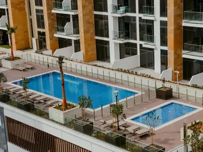 an overhead view of a swimming pool on a building at Modern Oasis: Spacious Studio Near Dubai Downtown in Dubai