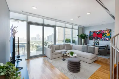 a living room with a white couch and windows at Burj Daman, DIFC Dubai - Mint Stay in Dubai