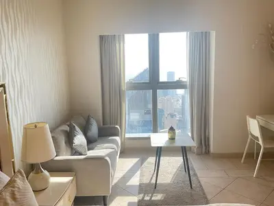 a living room with a couch and a large window at Stunning Marina View! CoLiving Rooms in Princess Tower Marina in Dubai