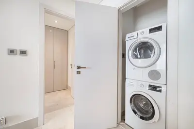 a laundry room with a washer and dryer at 2BR with Sea View & Terrace in Dubai