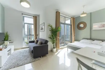 a living room with a bed and a couch at HAVN - Studio Unit in Claren Tower, Downtown Dubai in Dubai