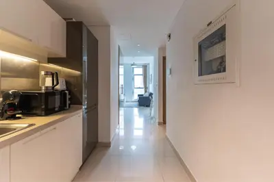 a kitchen with white cabinets and a counter top at HAVN - Studio Unit in Claren Tower, Downtown Dubai in Dubai