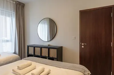 a bedroom with a bed with a mirror and a mirror at Central 1BR with Downtown Fountain Views in Dubai