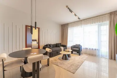 a living room with a table and chairs at Central 1BR with Downtown Fountain Views in Dubai