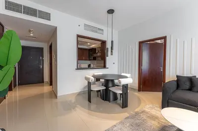 a living room with a table and a couch at Central 1BR with Downtown Fountain Views in Dubai