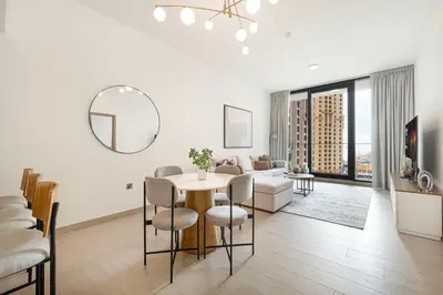 a living room with a table and a couch at Sophisticated 1 Bed Suite in Dubai Marina in Dubai